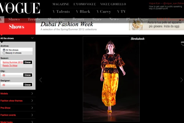 Model in a bold red-yellow fire-printed jumpsuit by Shrekahnth on the runway at Dubai Fashion Week Spring/Summer 2012, published on Vogue Italia.